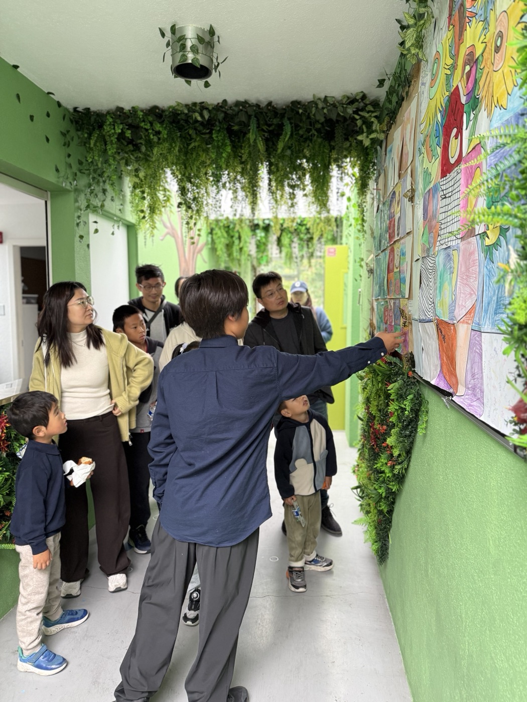A family touring the school art hallway