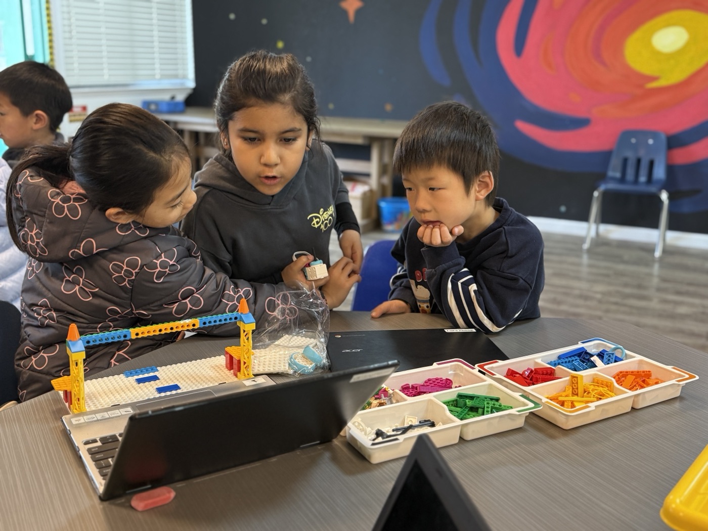 Students collaborating on a LEGO robotics build